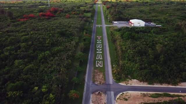 Tilt down drone shot of Broadway road at Tinian Island