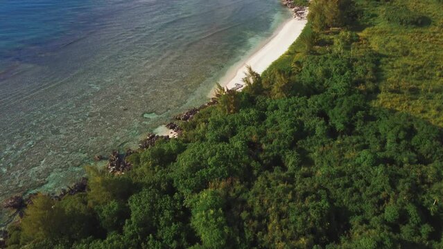 Tilt up shot of coastline of Tinian Island
