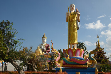 An outdoor statue of Phra Siwali is decorated for Buddhists to admire and there is a Phra Sri Ariyamettriya Borom Bodhiyan in the background at Wat Saeng Kaew Phothiyan temple. at Chiang Rai ,Thailand