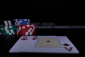 Dealer or croupier shuffles poker cards in a casino on the background of a table, chips. Concept of poker game, game business. Playing for money, a big win, a jackpot, gambling, a desire to get rich.	
