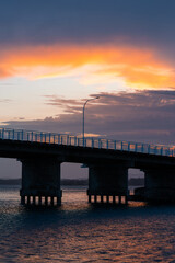 Fototapeta na wymiar A light pole on the bridge at sunset time.