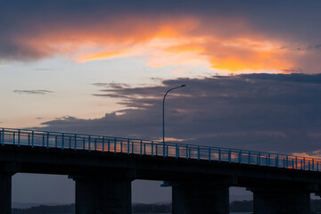 A light pole on the bridge at sunset time.