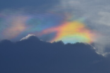 Fototapeta premium Clouds in the sky with Iridescent Rainbow - Holographic