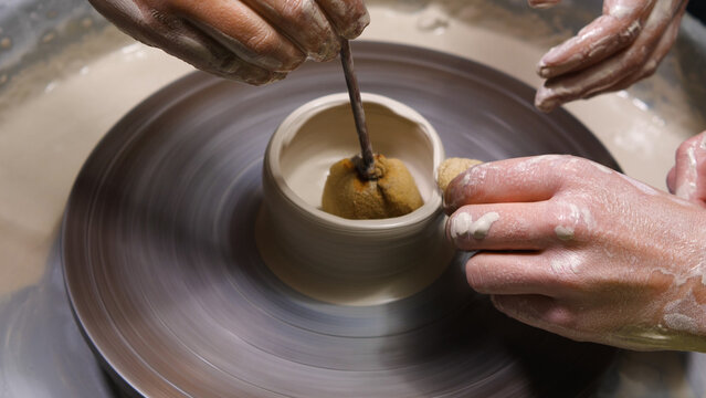 Premium Photo  Potter makes on pottery wheel clay pot and conducts master  class hands of master and child close up