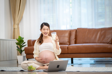 Pregnant woman drinking milk at home
