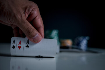 Aces in poker player hand in Best gamble in poker or lucky hand concept with player going all in...