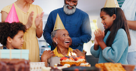 Cake, happy and family at birthday party celebration together at modern house with candles. Smile, excited and young children with African father and grandparents with hat for sweet dessert at home. - obrazy, fototapety, plakaty