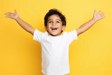 Fotobehang little boy smiling on yellow background © Neha