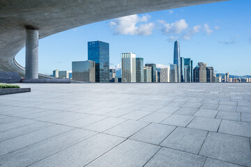 Empty square floor and bridge with modern city buildings in Shenzhen, China.