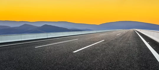 Poster Im Rahmen Asphalt highway road and mountain natural landscape at sunrise © ABCDstock