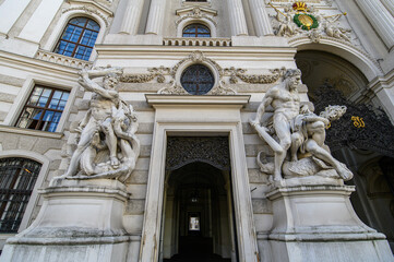 Obraz premium Baroque statues on the entrance gate of St. Michael's Wing of Hofburg Palace on Michaelerplatz in Vienna, Austria