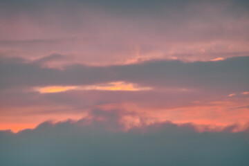 A beautiful sky tinted by the sun leaving vibrant shades of gold, pink, blue and multicolored. Clouds in the twilight evening and morning sky. Image of a cloudy sky in the evening and during the day