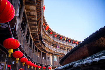 Fototapeta na wymiar Red Chinese lanterns in a Hakka Tulou traditional housing, Fujian.