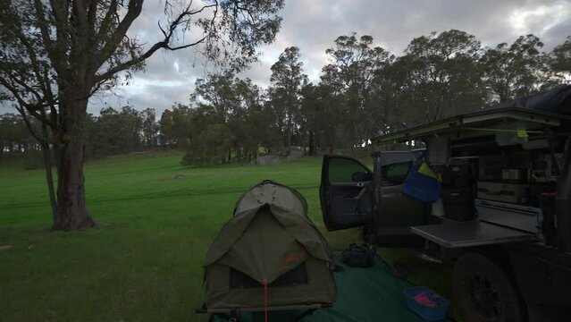 Camping set up in Australia, panning shot revealing swag, 4wd with canopy and ensuite tent.