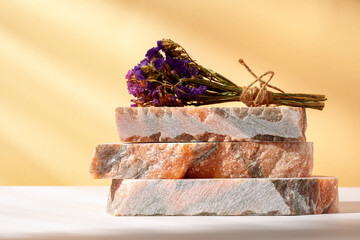 Pieces of granite stones against beige background with shadows