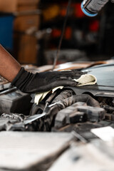Fototapeta na wymiar Close up of hands of auto mechanic working in a garage