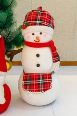 a cute snowman in the indoor at vertical composition