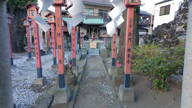 Rolling Shot of Walking Through Torii Gates towards Small Japanese Shinto Shrine in Tokyo Japan