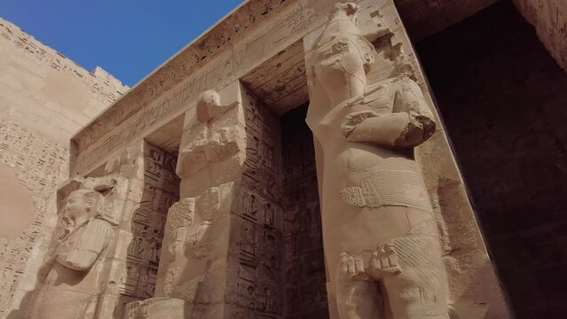 Luxor, Egypt - November 26 2023: The Ramessid columns in the peristyle court of the famous temple of Ramesses III in Medinet Habu on Luxor near the Valley of Kings in upper Egypt. 