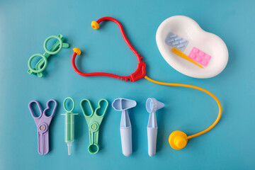 Medical instruments of different colors for children. Stethoscope, syringe, scissors, glasses....