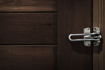 Latch for lock a wooden door. Security and privacy in the room. Do not disturb.