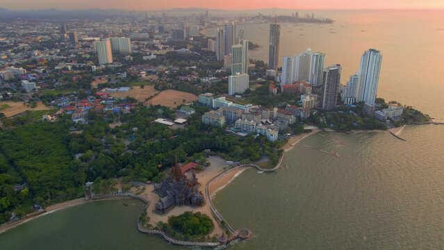 The Sanctuary of Truth wooden temple in Pattaya Thailand is a gigantic wood construction located at the cape of Naklua Pattaya City. sCity skyline of Pattay during sunset