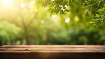 Empty wooden tabletop on blurred abstract green foliage background from garden on sunny background....