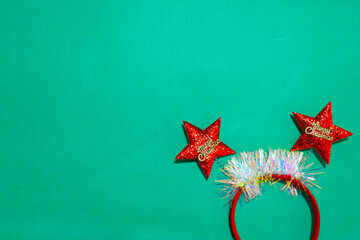 decorated Beautiful headband funny red star isolate on a green and red backdrop. concept of joyful...