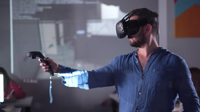 Architect Engineer Using Virtual Reality Software for His Project. Man with Headset and Controllers wearing VR headset for working design 3D architectural building model with BIM technology and