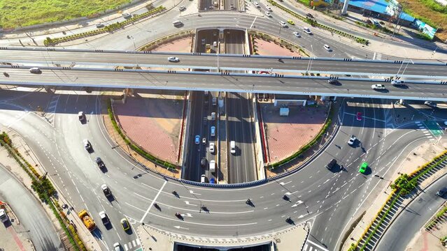 A visionary design combining a circular roundabout and a tunnel with state-of-the-art technology, symbolizing progress and innovation in transportation. Car and city concept. Aerial view drone.
