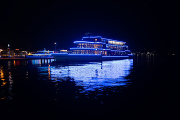 Panta Rhei passenger ship docked on lake Zurich at night, Beautiful blue lights reflected in the...