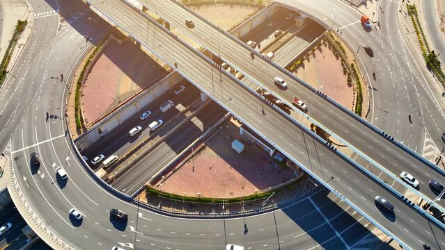 Aerial drone of an innovative interchange roundabout with an underground tunnel, a futuristic marvel melding urban infrastructure and technology into a harmonious blend of form and function. 4K HDR.

