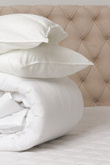 Fototapeta na wymiar Soft folded duvet and pillows on bed 