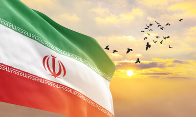 Waving flag of Iran against the background of a sunset or sunrise. Iran flag for Independence Day....