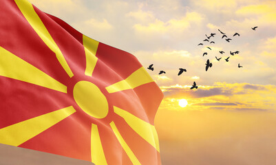 Waving flag of Macedonia against the background of a sunset or sunrise. Macedonia flag for...