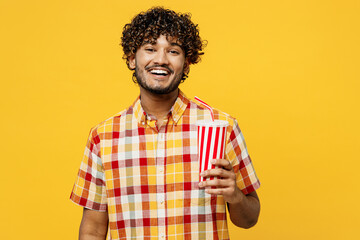 Young smiling cheerful happy Indian man he wearing shirt casual clothes hold cup of soda pop cola...