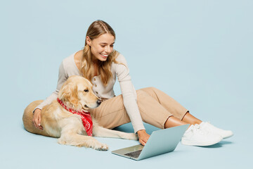 Full body young owner IT woman she wear casual clothes sit near her best friend retriever dog hold...