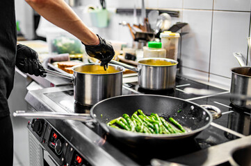 Chef hands cooking cheese sauce in the restaurant kitchen