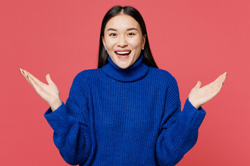 Young surprised excited astonished woman of Asian ethnicity she wear blue sweater casual clothes...