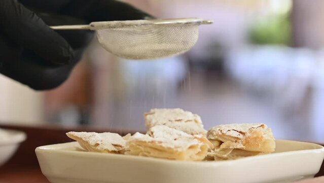 Freshly baked kurt pastry is sprinkled with powdered sugar
