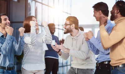 Business people celebrates and clench their fists in the air as a winning team