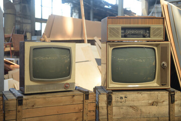 Two old TVs are in the hangar. Retro technology concept.