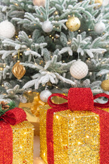 New Year and Christmas. A classic light and cosy room with a fireplace, candles, a snowy Christmas tree and plenty of garlands and lights.