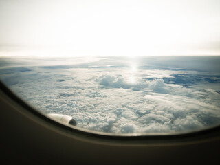 A scenery outside the airplane window showing many clouds.