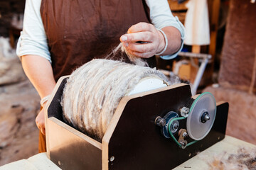 Crop worker working using wool spinning wheel machine