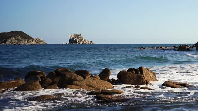 Slow motion seascape with rocks.