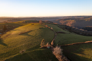 Aerial view of countryside during falls with fields, road and nice sunset