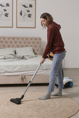Housewife vacuuming the room, domestic life, apartment cleaning concept