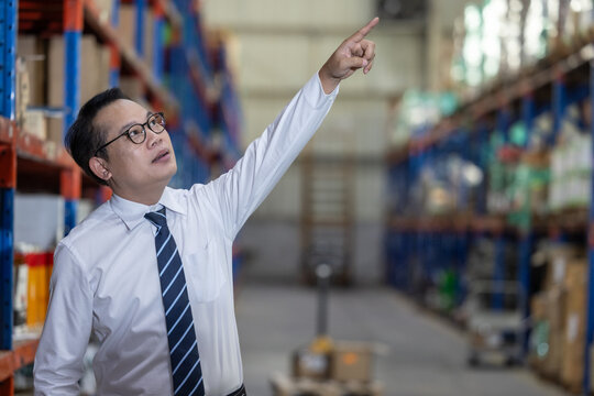 Warehouse manager process paperwork, organize goods by size, shape, category, prepare delivery date