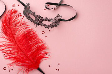 Unleash desire with adult boutique delights. Top-view photo of sensual tools—lace mask, feather...